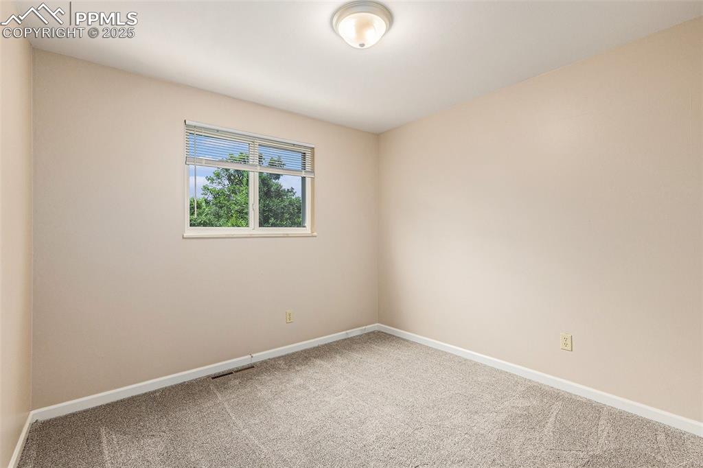 Image 17 of 29: Bedroom with new carpet floors and baseboards