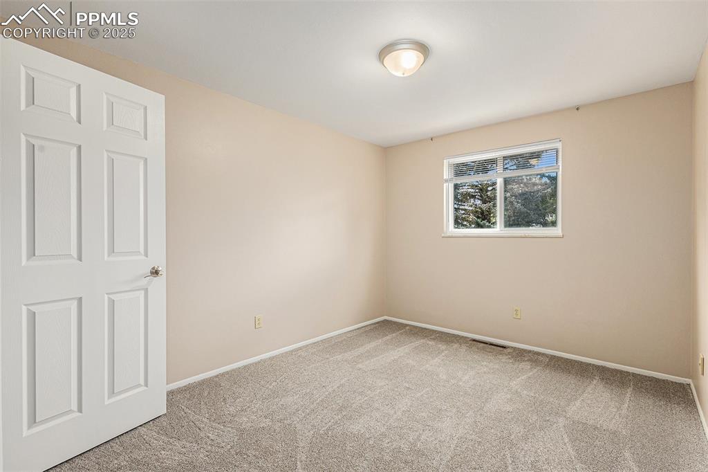 Image 18 of 29: Newly carpeted bedroom with baseboards