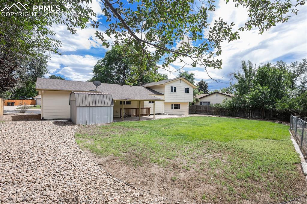 Image 29 of 29: Back of property with a fenced backyard, roof with shingles, a patio area,