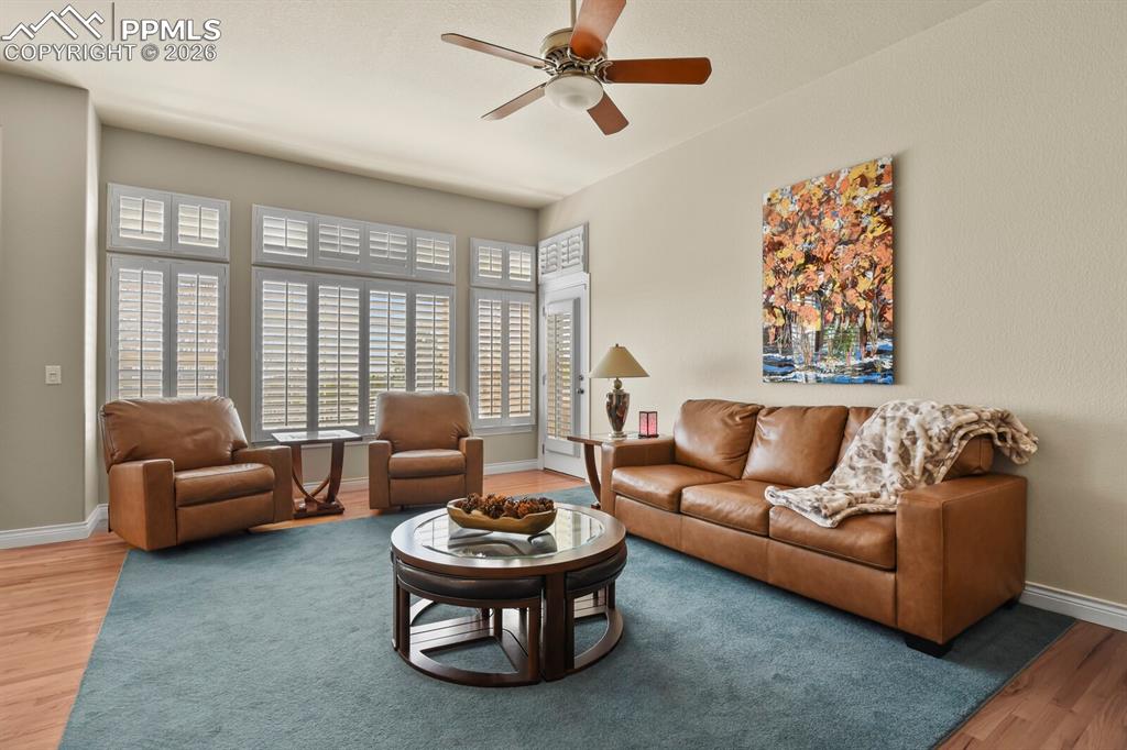 Image 14 of 46: Another view of the Living area showing the bank of windows and the door to