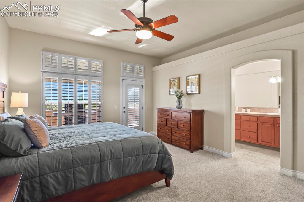 Image 16 of 46: Carpeted room featuring a ceiling fan, windows with plantation shutters, th