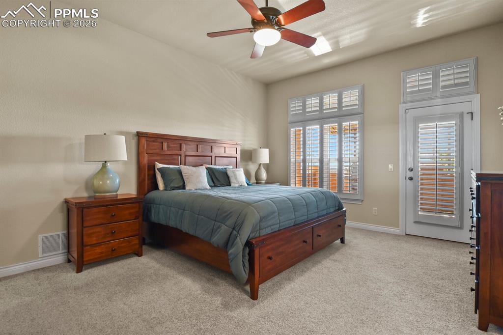 Image 17 of 46: Another view of the large primary bedroom on the main floor of the home. 
