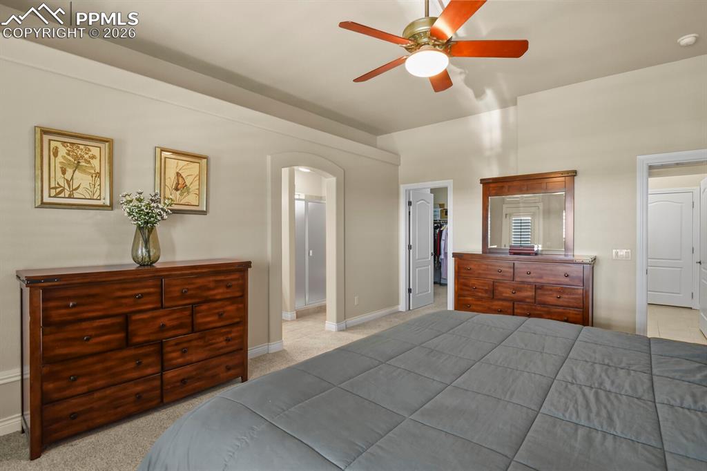 Image 18 of 46: Another view of the primary bedroom showing the door to the large walk-in c