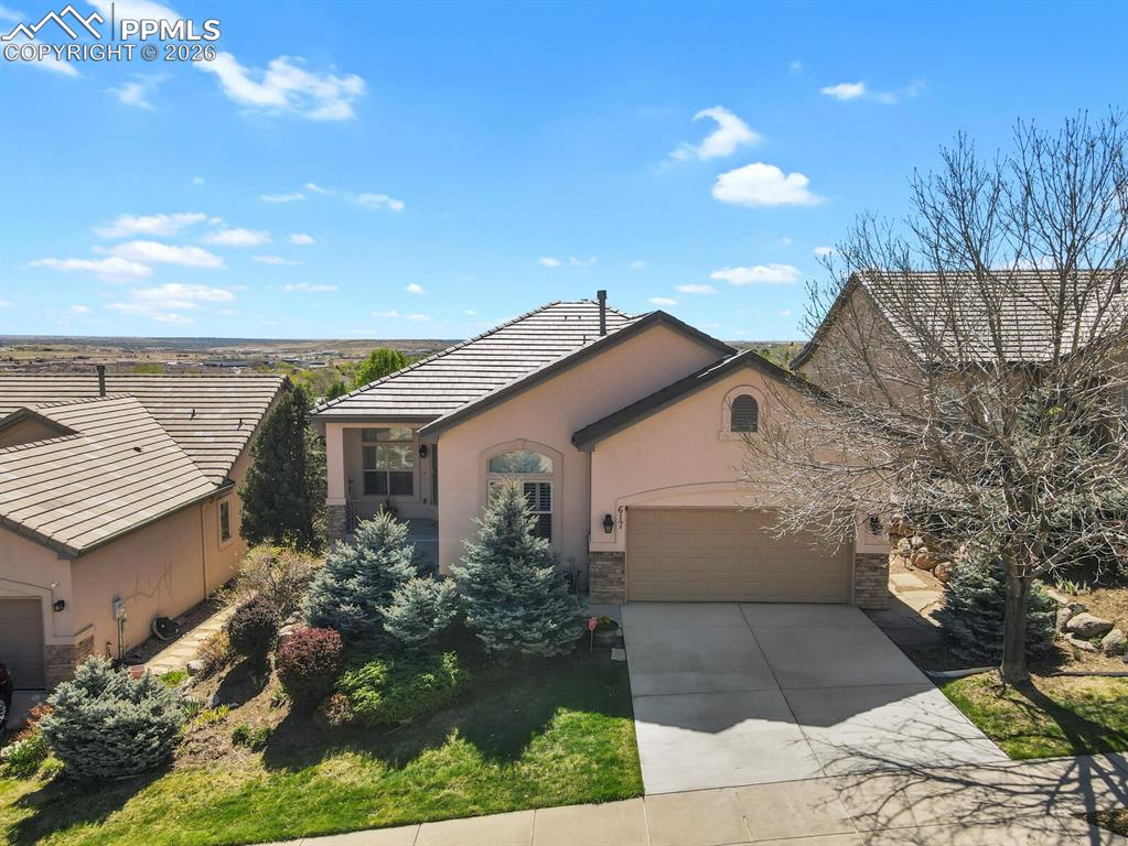 Image 2 of 46: Aerial view of this stucco ranch with stone accents, a tiled roof, and a co