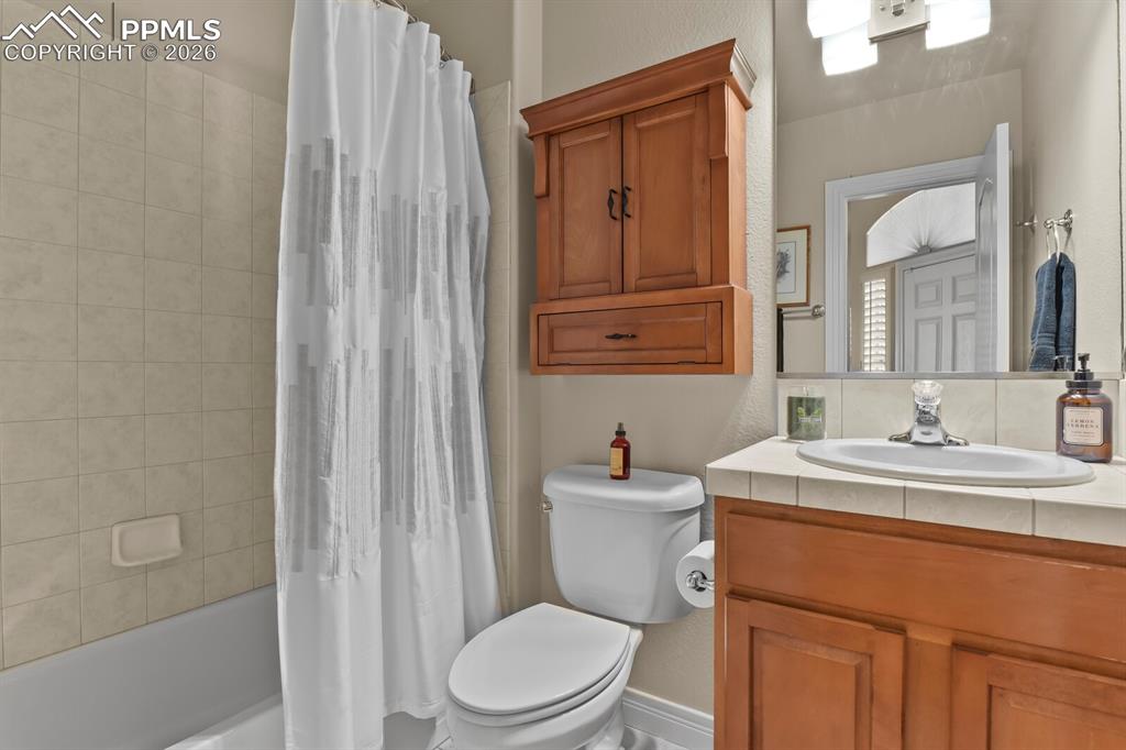 Image 22 of 46:  Main floor Bathroom featuring a built-in bathtub with tiled surround, a to