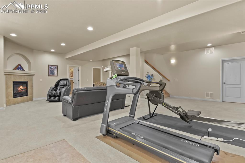 Image 28 of 46: Another view of the spacious Family Room showing the gas fireplace.  