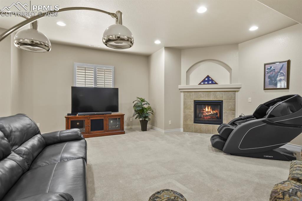 Image 30 of 46: This inviting living space features light-colored carpeting, recessed light