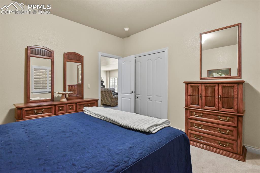 Image 34 of 46: Fourth bedroom features light-colored walls and carpeted flooring.