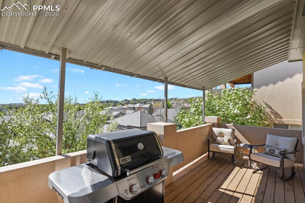 Image 37 of 46: The property features a covered outdoor patio with a corrugated metal roof,