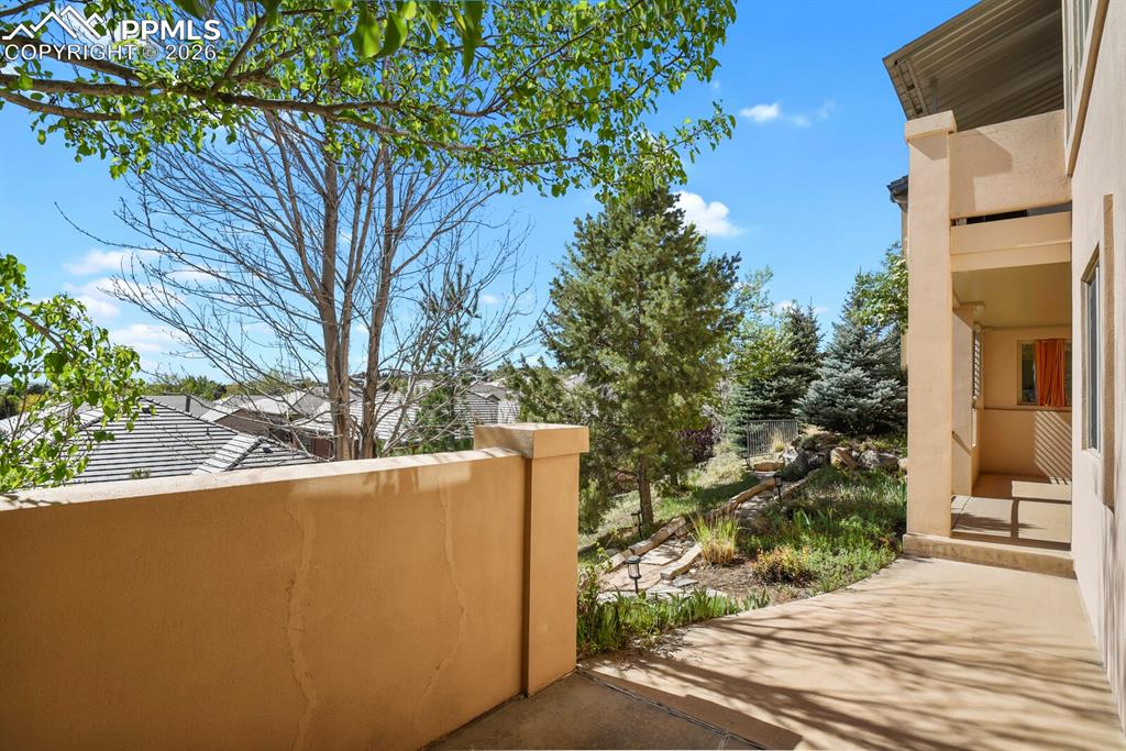 Image 39 of 46: The property features a second covered outdoor patio area with a stucco wal