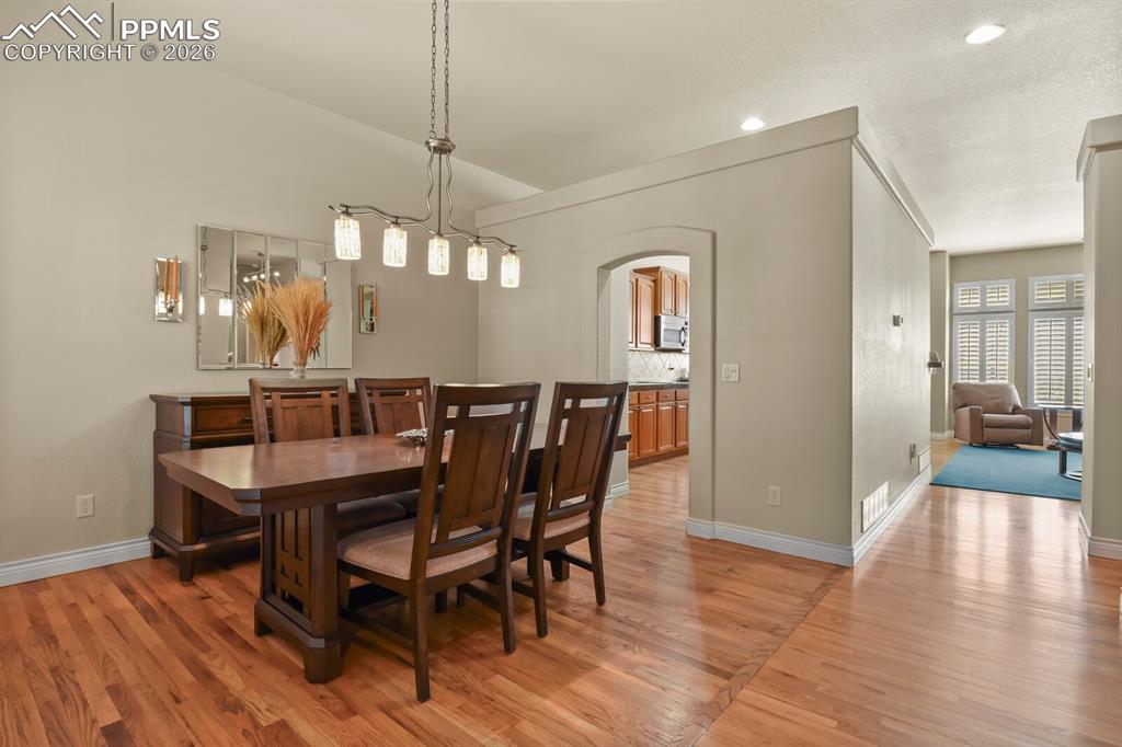 Image 5 of 46: This  separate formal dining area features hardwood floors, archway to the 