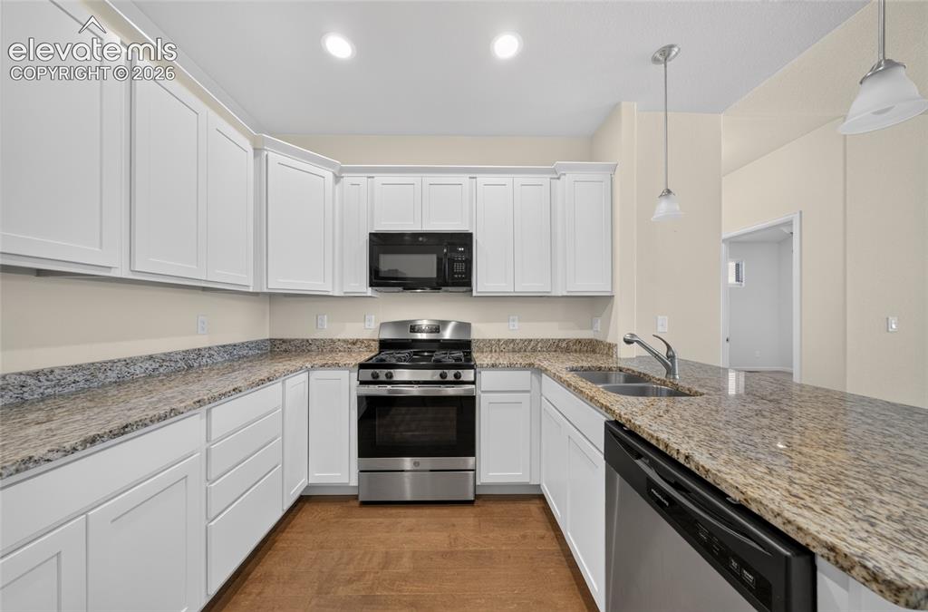 Image 14 of 43: Kitchen featuring ample cabinetry, generous counter space and breakfast bar