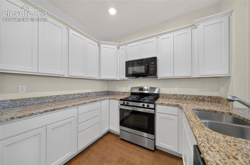 Image 15 of 43: Bright kitchen with ample cabinetry.