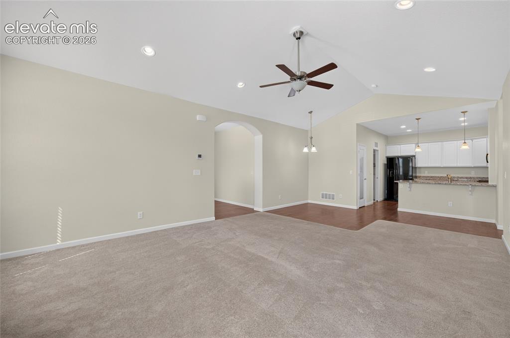 Image 16 of 43: Spacious living room featuring an open, inviting layout with abundant natur