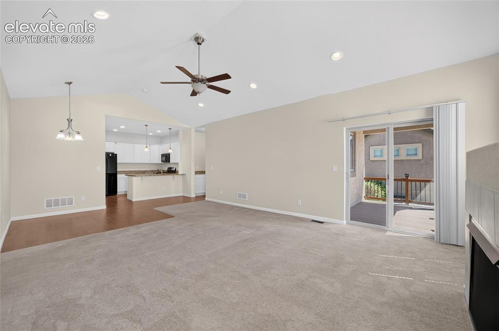 Image 17 of 43: Open concept living room with gas fireplace