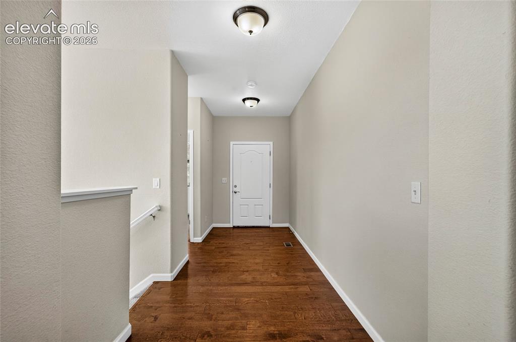 Image 3 of 43: Front entrance with wood flooring.
