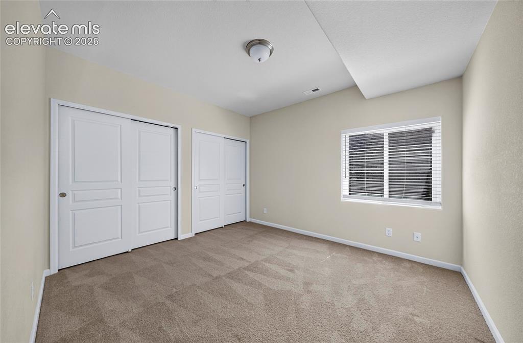 Image 31 of 43: Bedroom four. Bright and verstile bedroom offering comfotable lining space