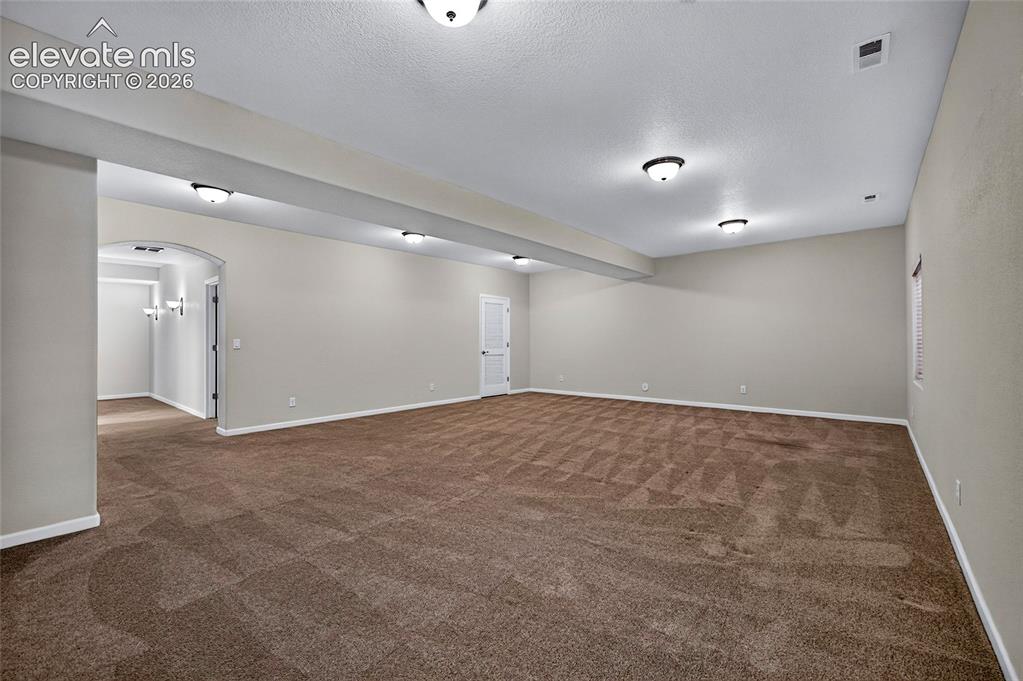 Image 38 of 43: Expansive great room offers abundant space for a family room, recreation ar