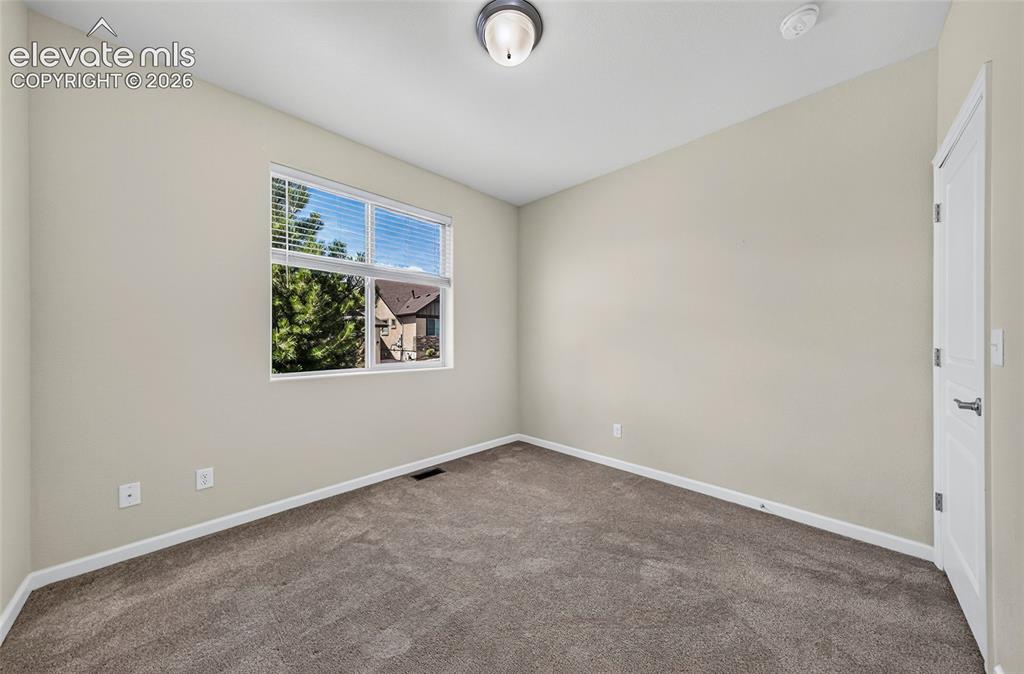 Image 4 of 43: Bedroom one. Bright spacious room. Perfect for a home office/ Bonus room.