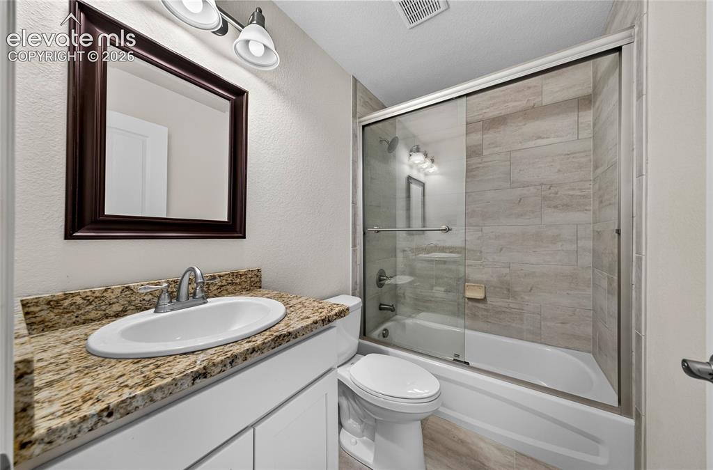 Image 5 of 43: Bathroom one with bright features.