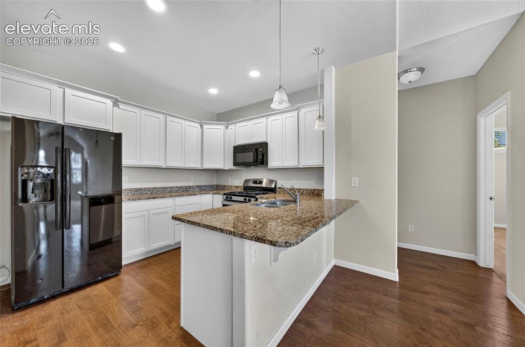 Image 8 of 43: Bright,open concept kitchen featuring ample cabinetry, generous counter spa