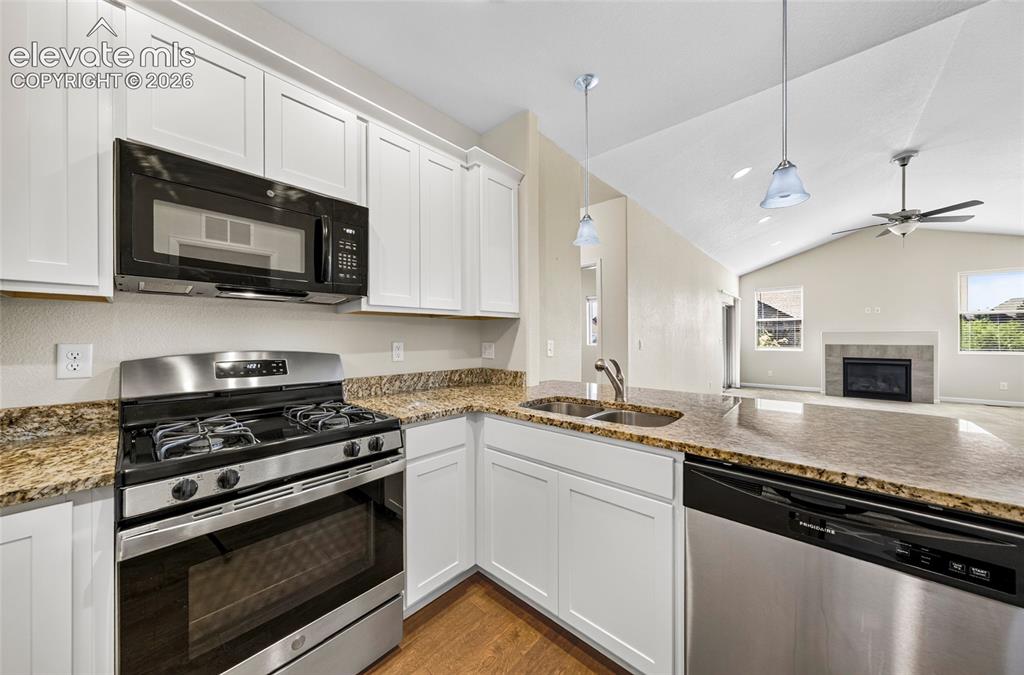 Image 9 of 43: Bright kitchen with granite countertops.