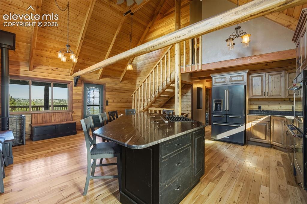 Image 18 of 43: Vaulted wood-paneled ceiling with exposed beams, wood-finish flooring, and 