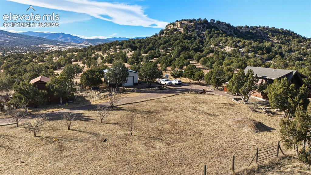 Image 2 of 43: Expansive grounds featuring mature oak and pine trees, open pasture acreage