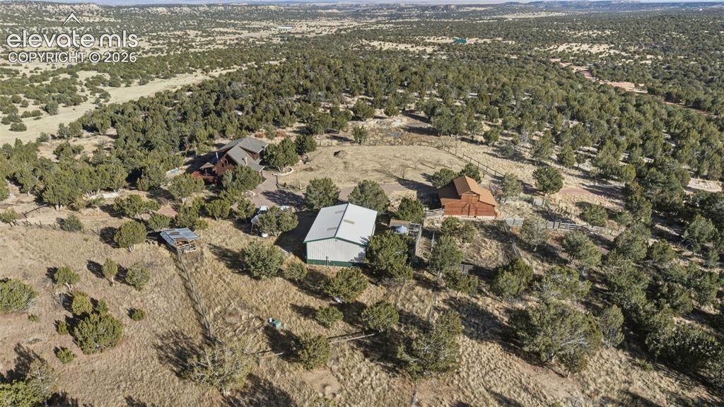 Image 36 of 40: Expansive property featuring a main residence, a barn, a large outbuilding,