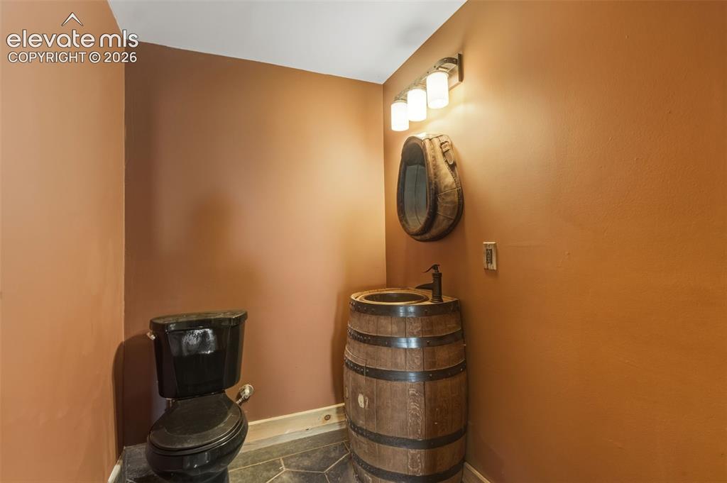 Image 40 of 43: Barrel-style vanity with vessel sink and dark bronze faucet, wall-mounted v