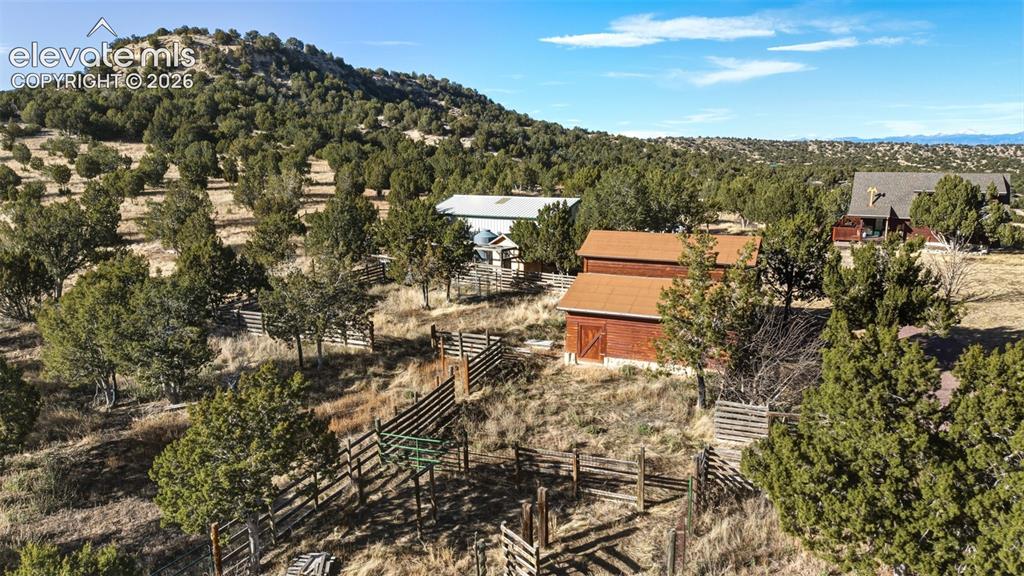 Image 8 of 43: Extensive natural landscaping with varied topography, multiple outbuildings