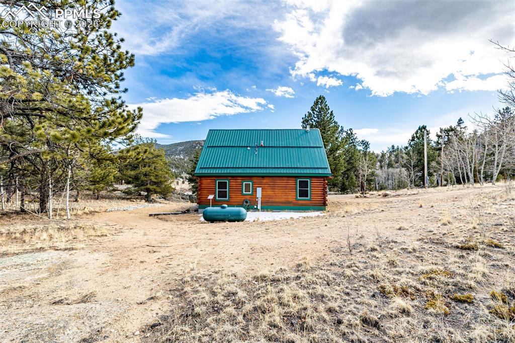 Image 34 of 35: Rear view of property with log siding