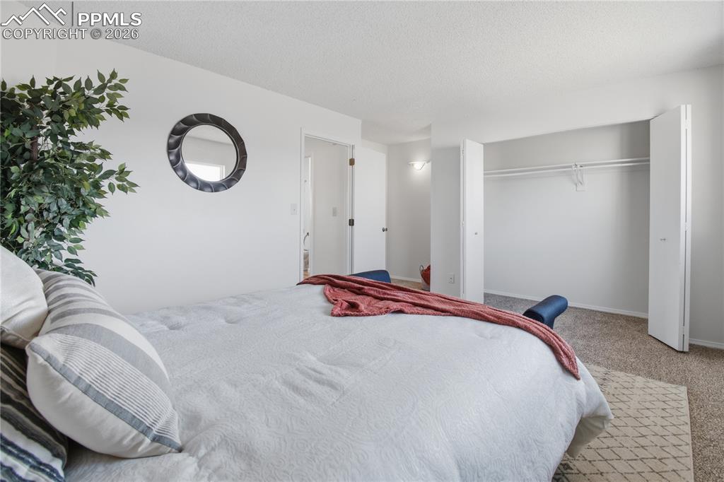 Image 17 of 29: Primary Bedroom with large closet and entry into bathroom.