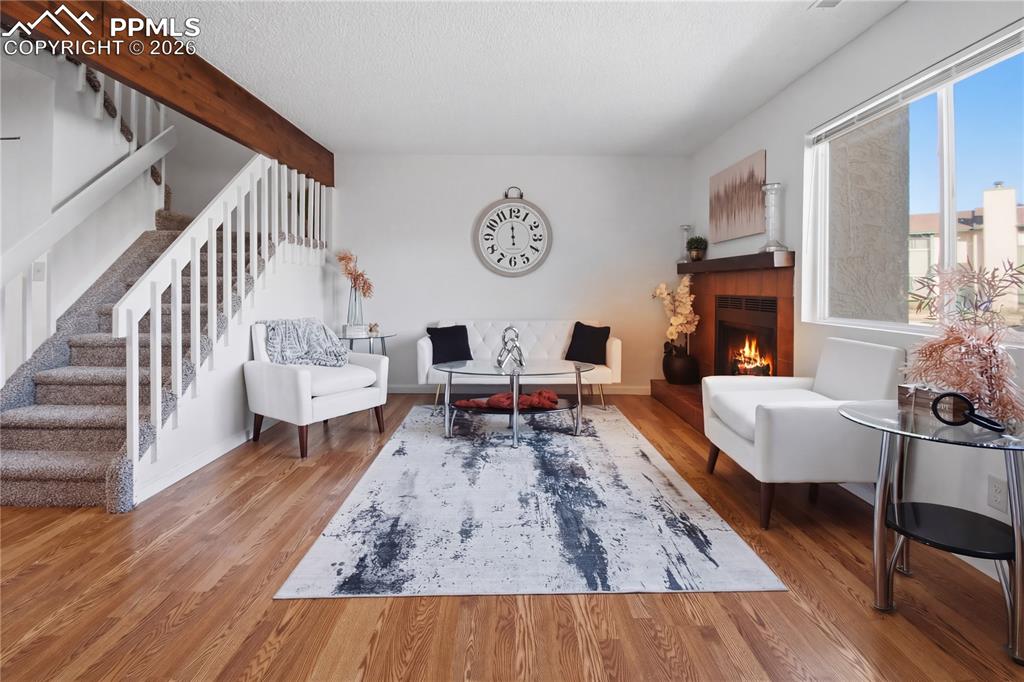 Image 4 of 29: Living room with wood burning fireplace