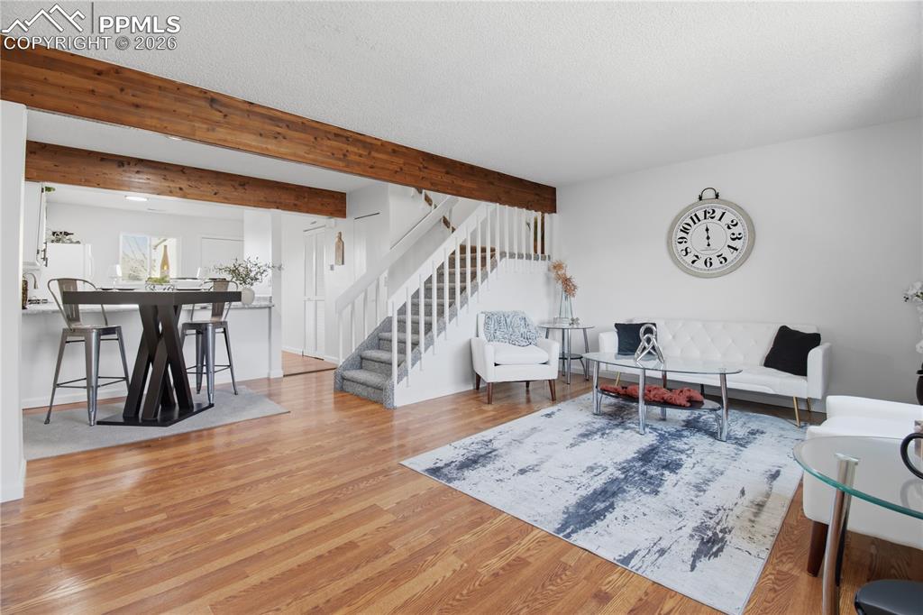 Image 7 of 29: Open floor plan, dining room and kitchen, wood beams, fresh paint.