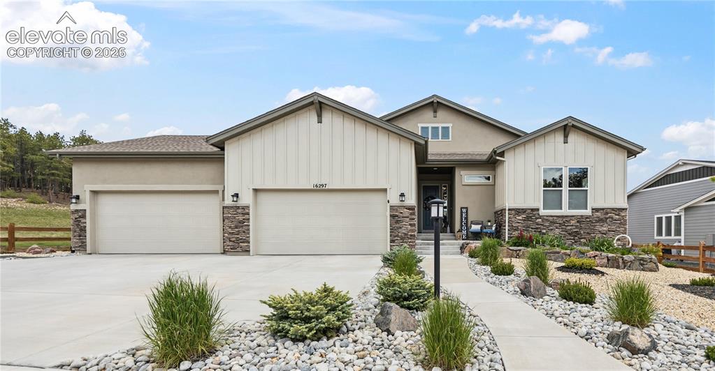 Image 1 of 50: Contemporary ranch-style residence featuring a stucco and board-and-batten