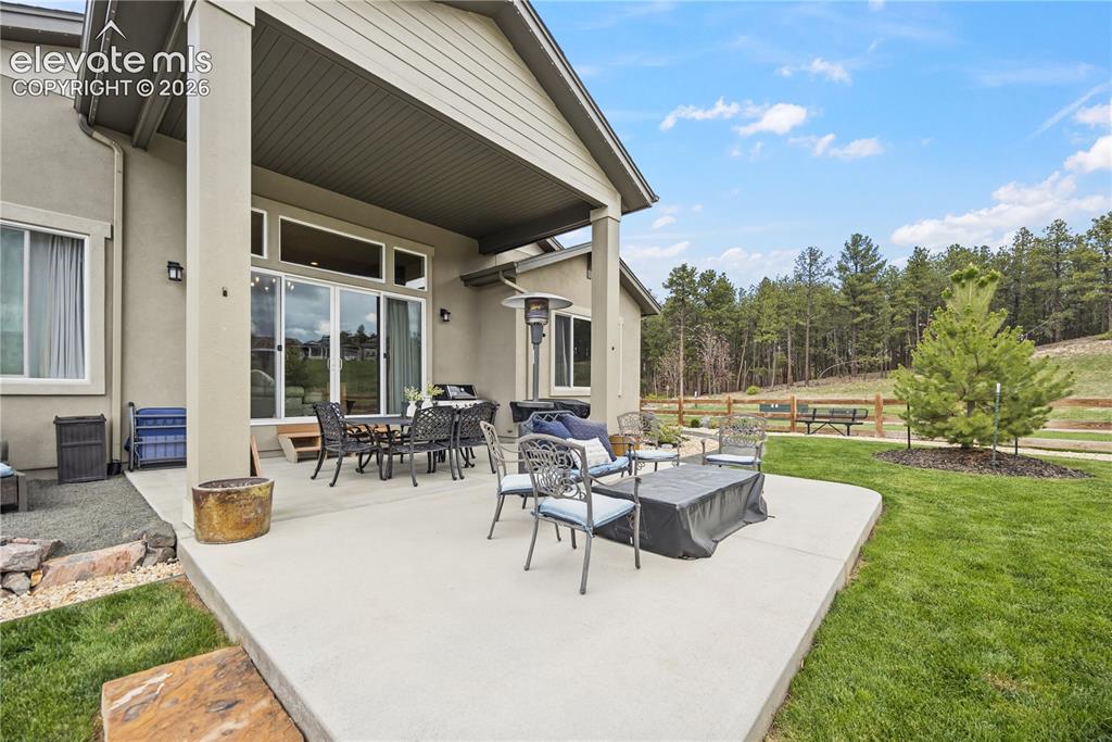 Image 15 of 50: Expansive concrete patio offering direct outdoor access through multiple sl
