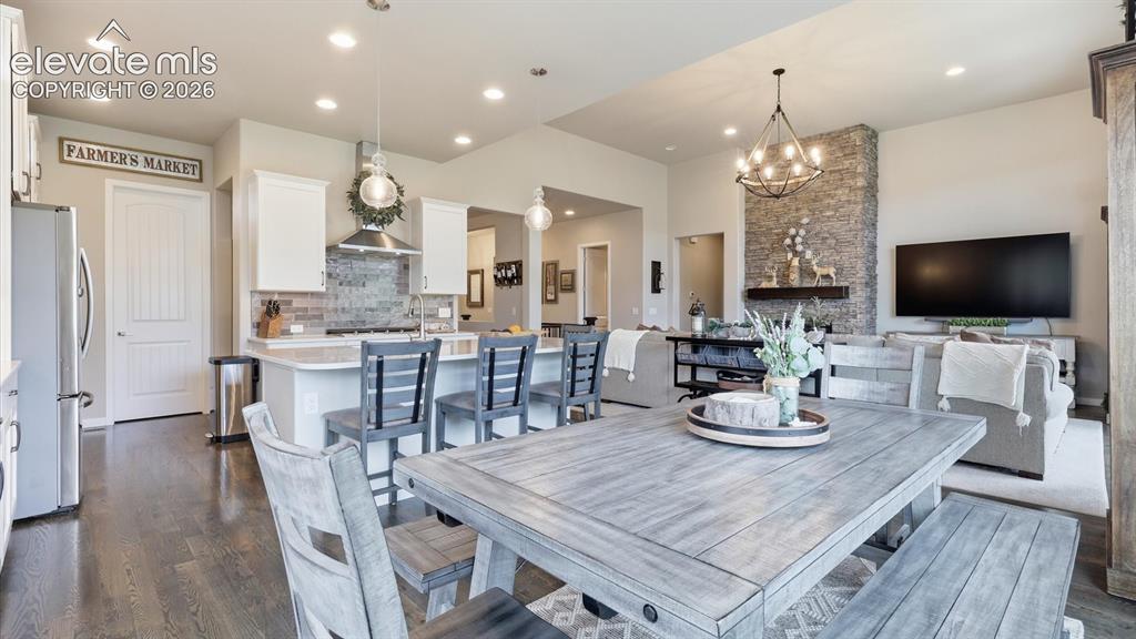 Image 15 of 50: DESIGNED FOR GATHERING — A stunning open-concept kitchen anchored by an ove