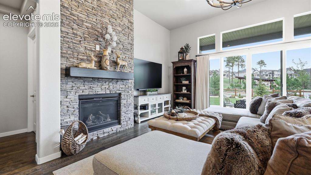 Image 2 of 50: A SHOWSTOPPING CENTERPIECE — The soaring stacked-stone fireplace brings war