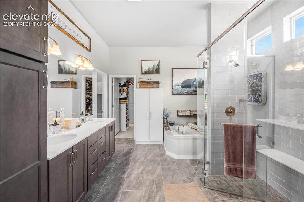 Image 20 of 50: Spacious bathroom featuring a dual vanity with undermount sinks, a corner s