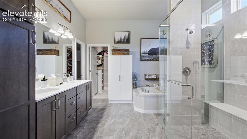 Image 22 of 50: LUXURY DESIGNED AROUND YOU — The spa-inspired primary bath flows into an ov