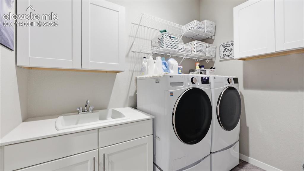 Image 24 of 50: ELEVATED EVERYDAY FUNCTION — A beautifully designed laundry room featuring