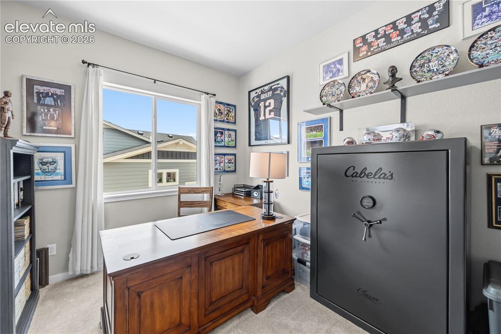 Image 26 of 50: Brightly lit room featuring a large window, neutral wall paint, and carpet