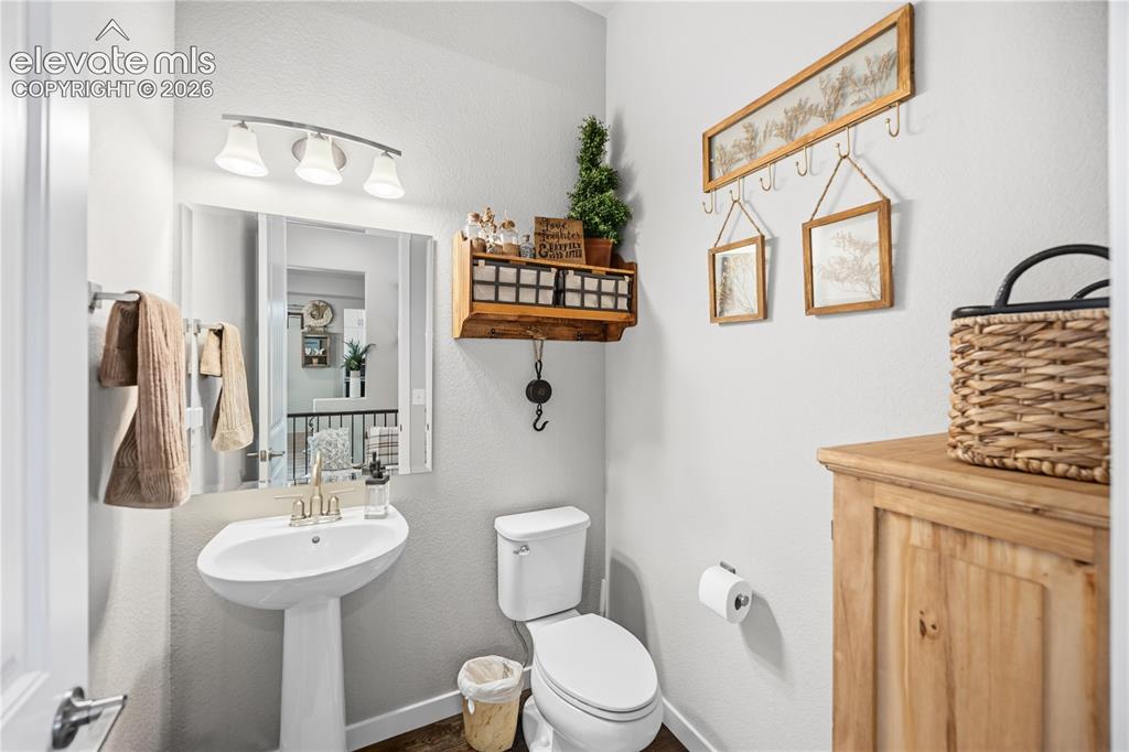 Image 29 of 50: Pedestal sink with a polished brass faucet, complemented by a wall-mounted