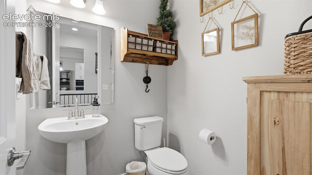 Image 30 of 50: REFINED DOWN TO EVERY DETAIL — Even the powder room makes a statement, show