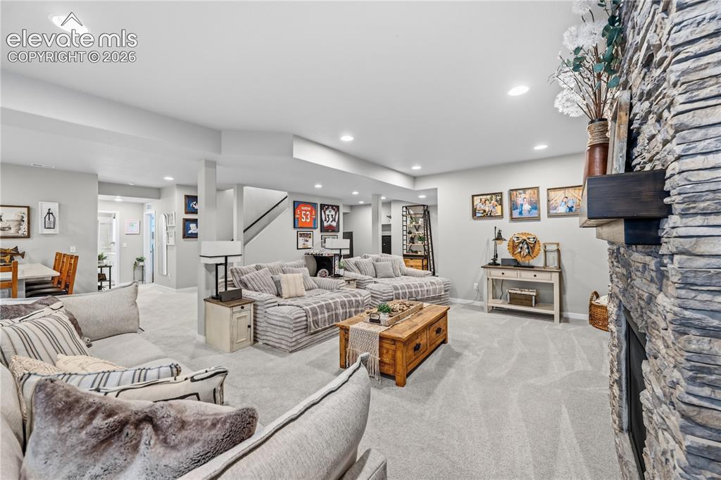 Image 33 of 50: Spacious lower-level living area with recessed lighting, light-toned carpet