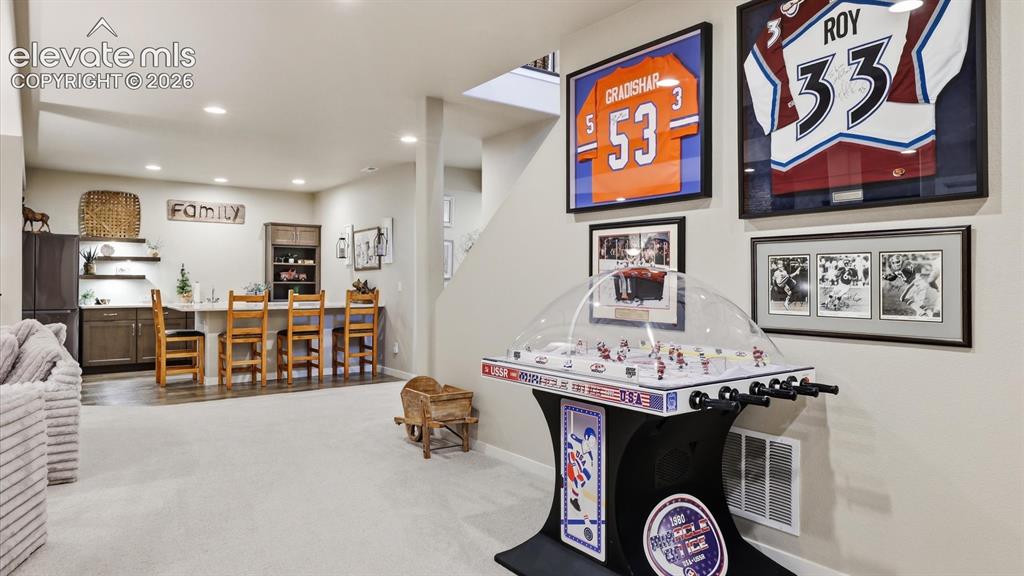 Image 33 of 50: LUXURY LIVING CONTINUES BELOW — A beautifully appointed family room with an
