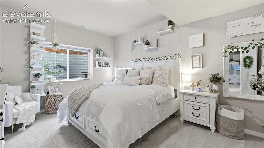 Image 36 of 50: SPACIOUS & SERENE — A generously sized lower-level bedroom offers a peacefu
