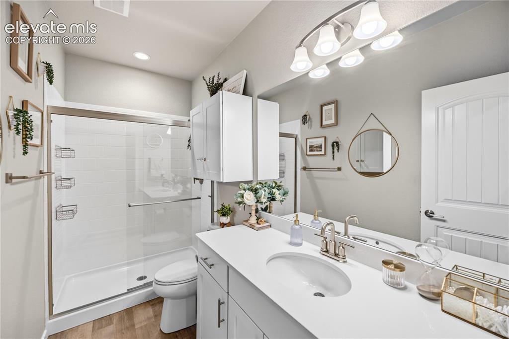 Image 39 of 50: Bathroom vanity featuring dual under-mount sinks with chrome fixtures