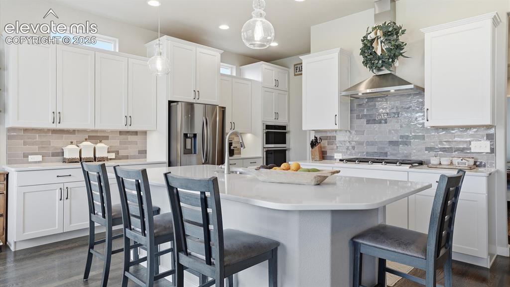 Image 4 of 50: TIMELESS STYLE, EFFORTLESS FLOW — Rich hardwood flooring enhances the expan